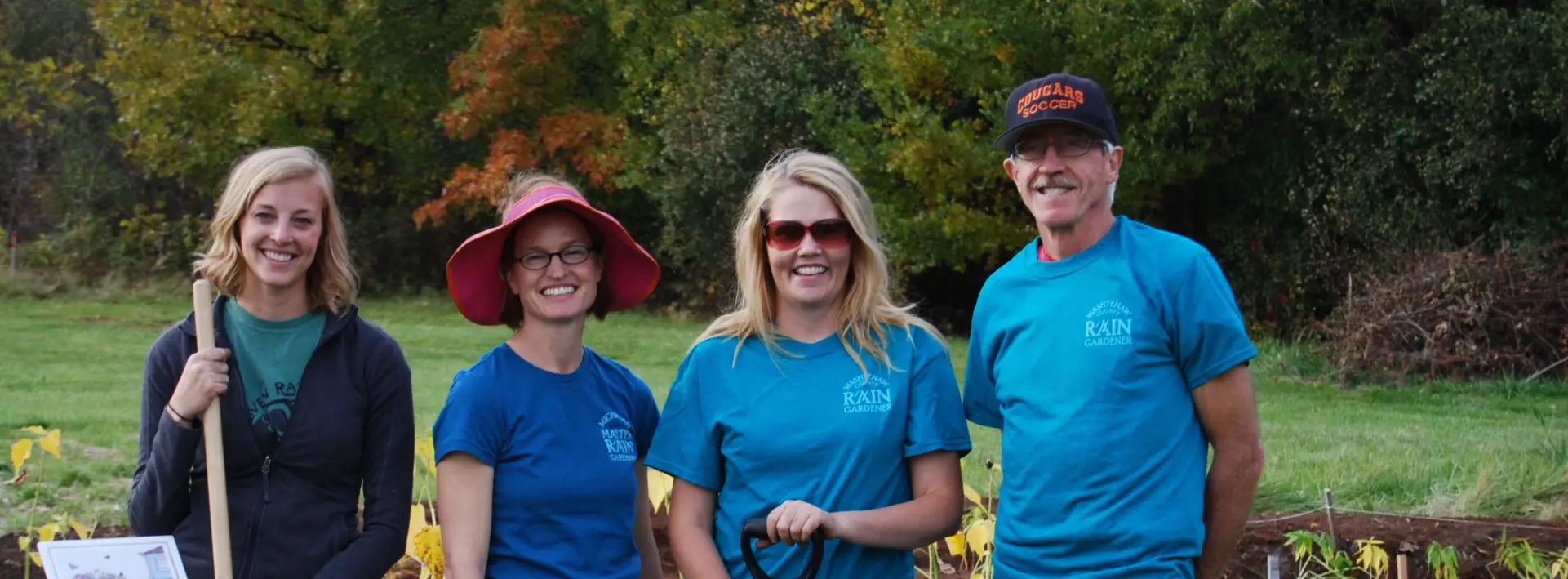 Master Rain Gardener volunteers planting native plants in a rain garden during a community conservation event.